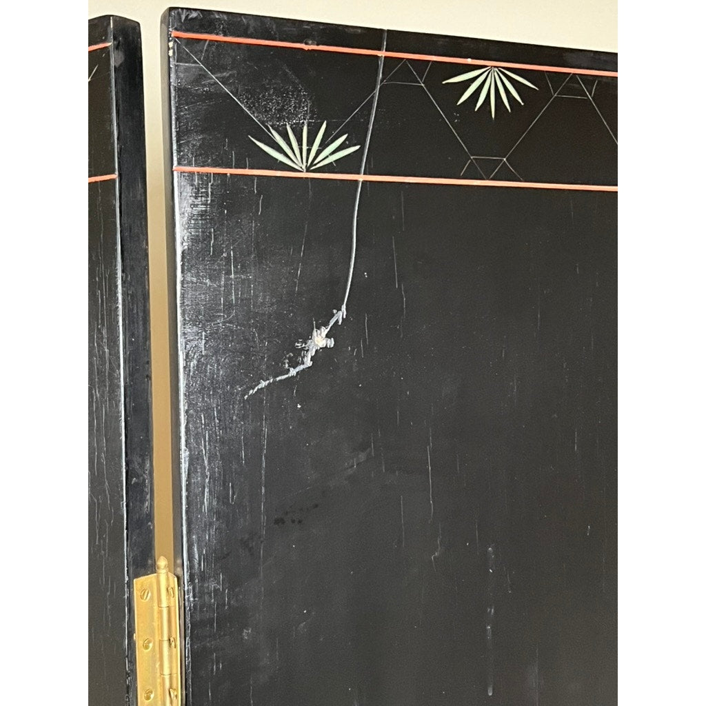 The Vintage Asian Black Lacquer Coromandel Room Screen features brass hinges, geometric lines, and green leaf patterns at the top, with a long vertical crack that highlights its classic Chinese decorative style.