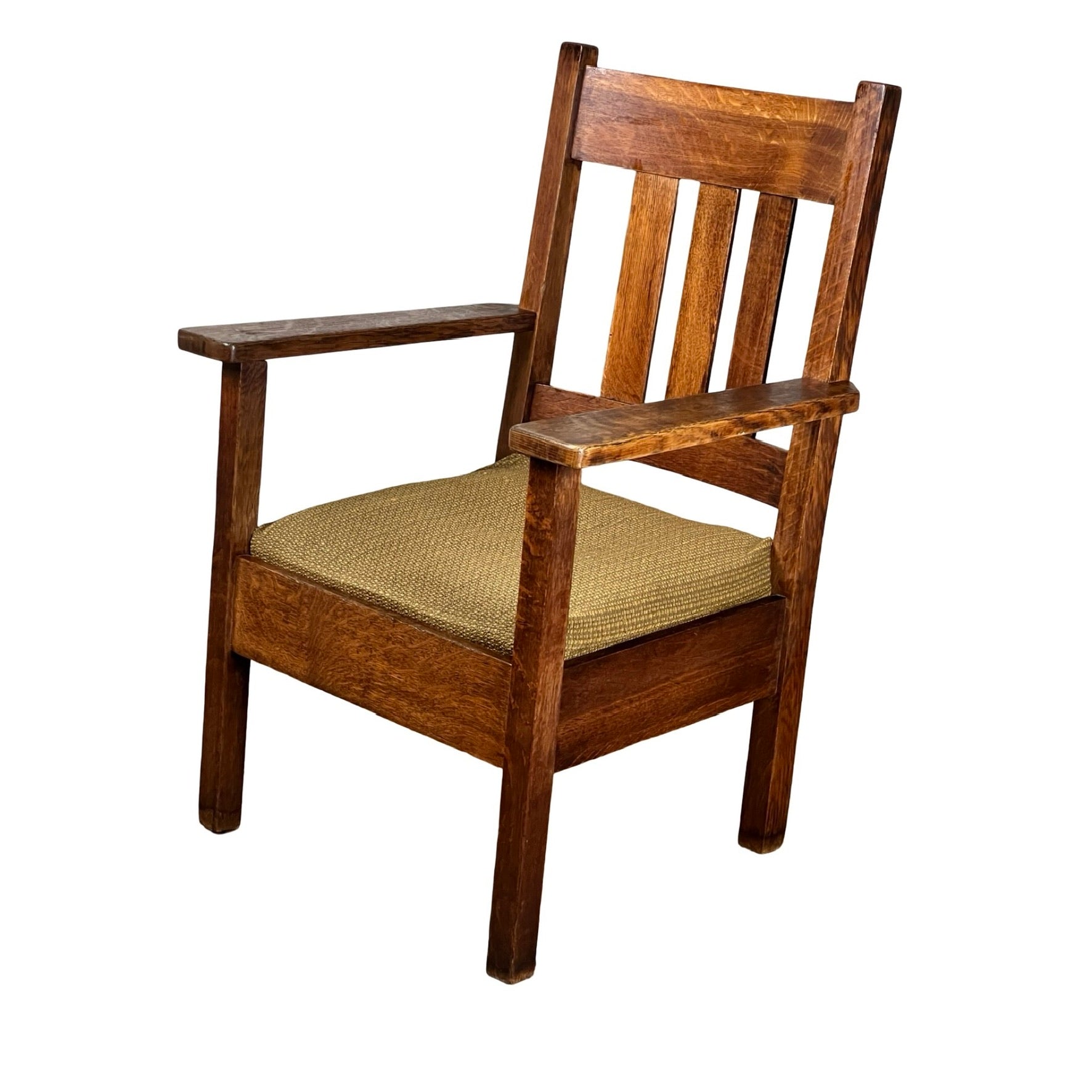 The Antique Quarter Sawn Mission Oak Arm Chair by Quaint Furniture (c. 1920) features a slatted back, straight armrests, and a woven seat cushion in a sturdy Arts & Crafts design with a natural oak finish.