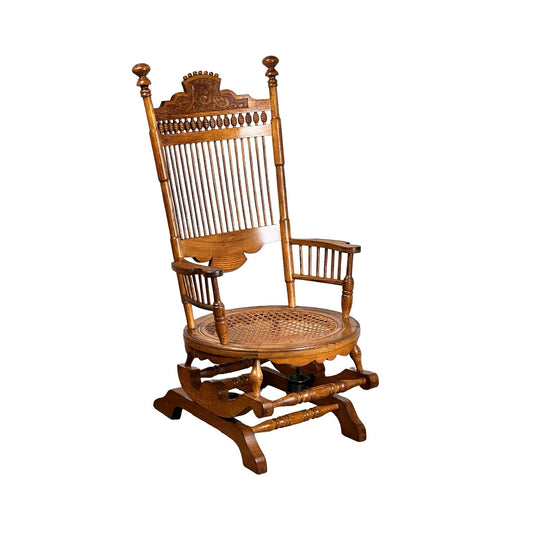 Antique Victorian Oak Platform Rocker, late 19th century, featuring a high spindle back, carved details, armrests, and woven cane seat—an elegant example of period furniture. Brand: None/Unknown. Set against a white background.