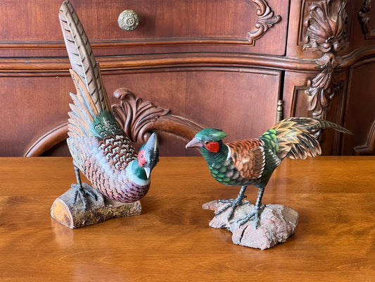 The Pair of Hand Carved Pheasants by Pearl City Antiques features two colorful, detailed figurines—one pecking, one standing upright—perfect unique decor items to add charm to any space.