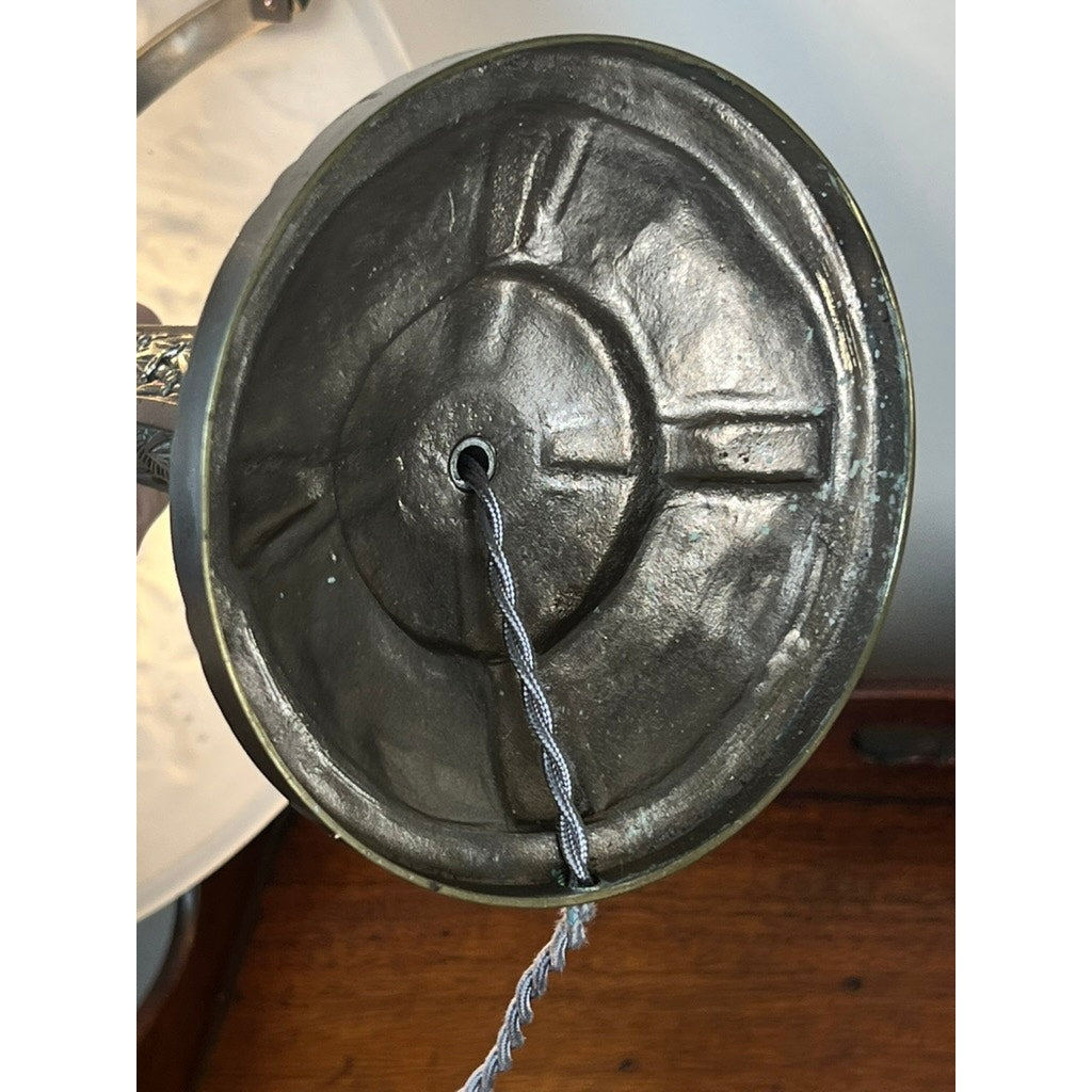 Close-up of a textured metallic ring with a central hole threaded by a braided cord, shown next to the frosted glass shade of a Vintage French Art Deco Table Lamp by Muller Frères Lunéville, c. 1920. Brand unknown.