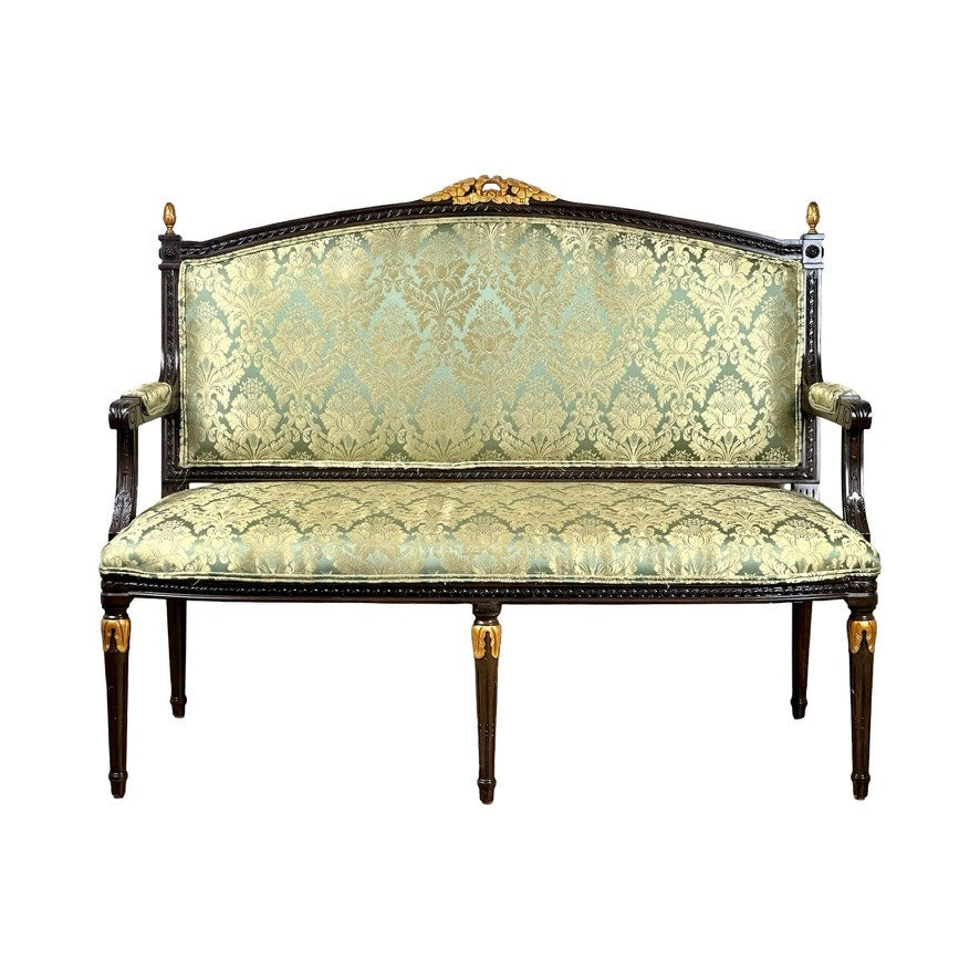 A Vintage Louis XVI Style Settee in green damask upholstery features ornate carvings, a floral pattern, and gold-accented frame and legs; brand: unknown.