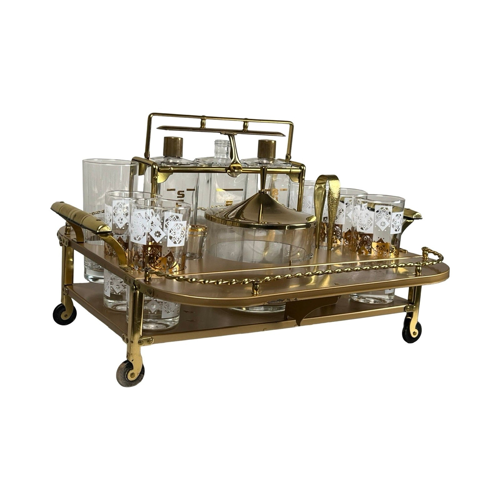 A Vintage Mid Century Modern Bar Caddy from the 1960s displays assorted glassware, gold-accented tumblers, and chic bar tools—perfect for stylish entertaining. Brand: unknown.