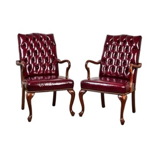 A pair of Chippendale style tufted burgundy leather library armchairs, featuring carved wooden frames with cabriole legs and armrests, are shown against a white background. Brand: None and/or Unknown.