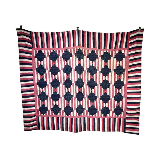 A matching pair of antique American patriotic hand-quilted Log Cabin quilts, c. early 20th century, features blue and pink geometric designs with bold navy, pink, and white striped borders—classic examples of timeless American quilting.