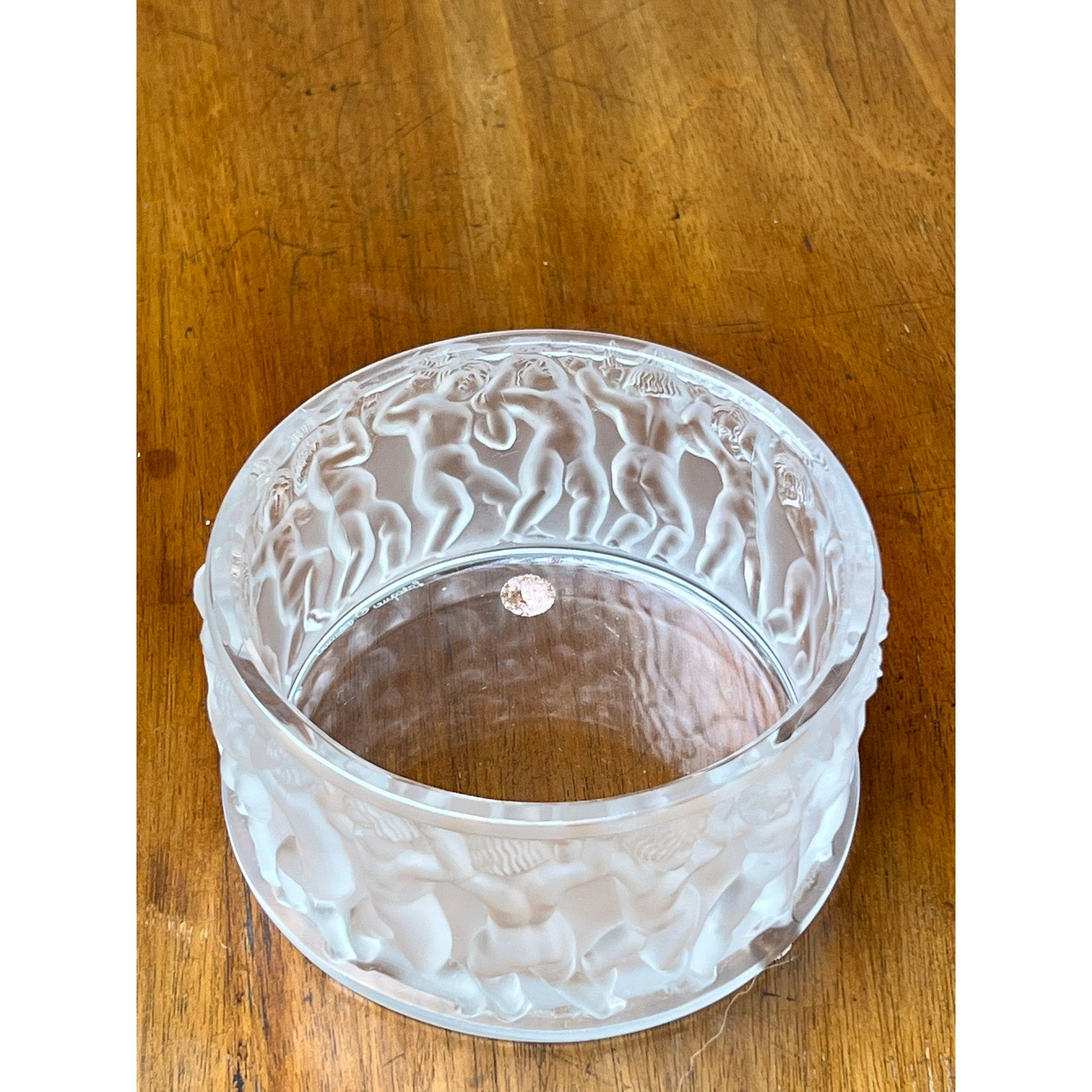 The Vintage Lalique Crystal Enfants Box by Lalique, featuring clear glass with a frosted, textured wavy pattern, sits elegantly on a wooden surface.