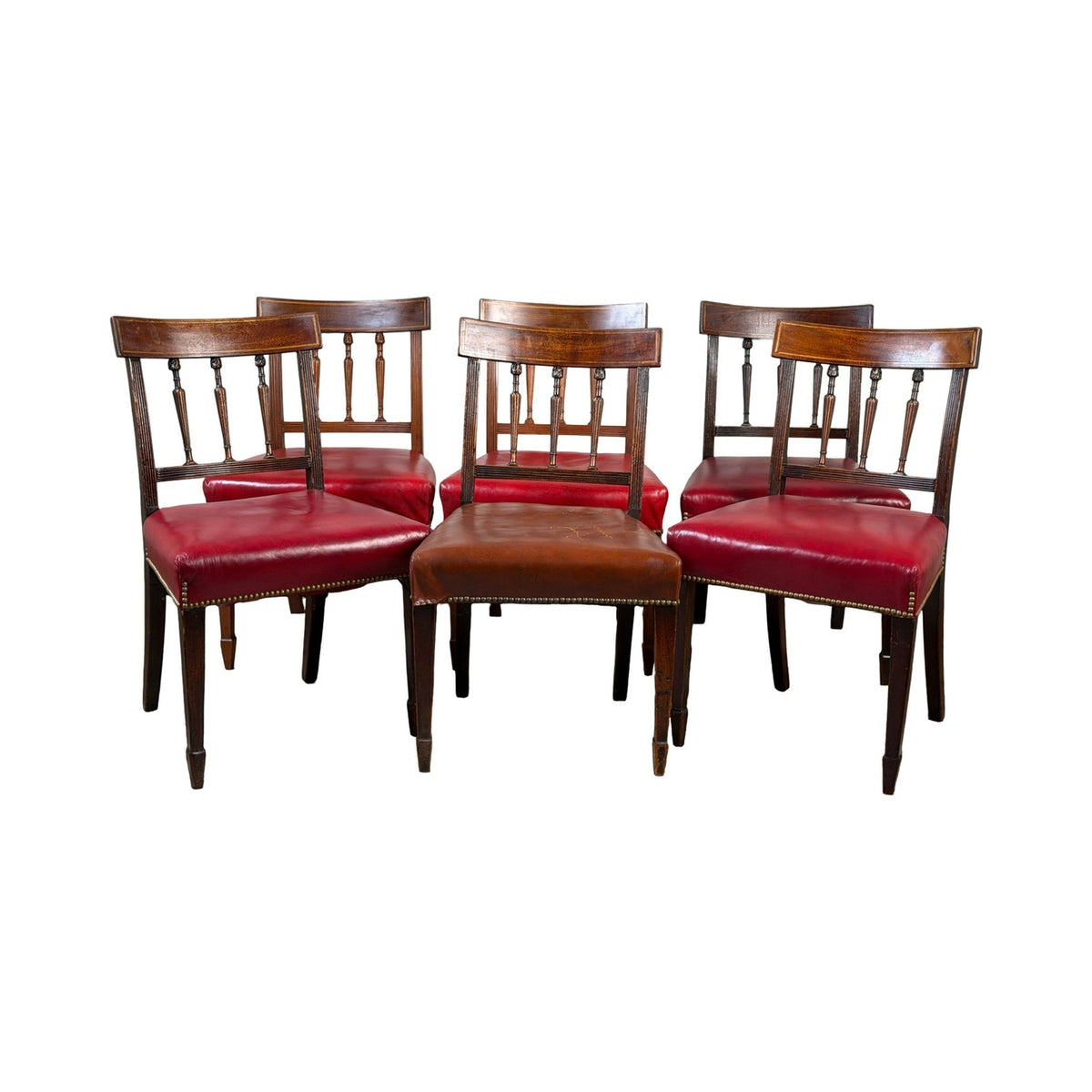 A set of six English George III mahogany neoclassical dining chairs, four from the 18th century by Pearl City Antiques, arranged in a staggered group against a white background.
