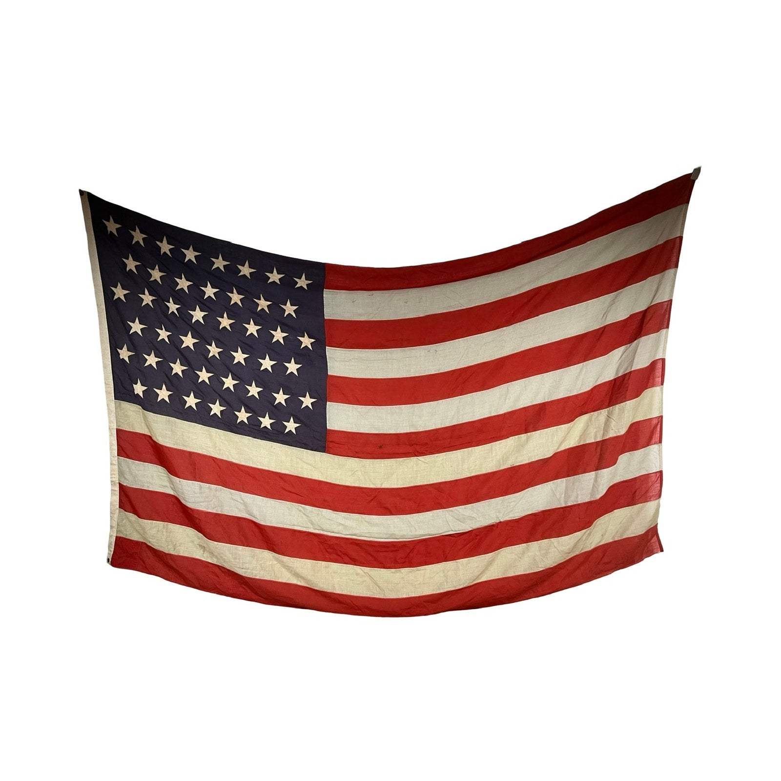 An Antique 45 Star American Flag from the Spanish–American War Era (9’9" x 6’) hangs against a plain white background, its slightly worn, wavy fabric evoking echoes of late 19th-century America. Brand: Unknown.