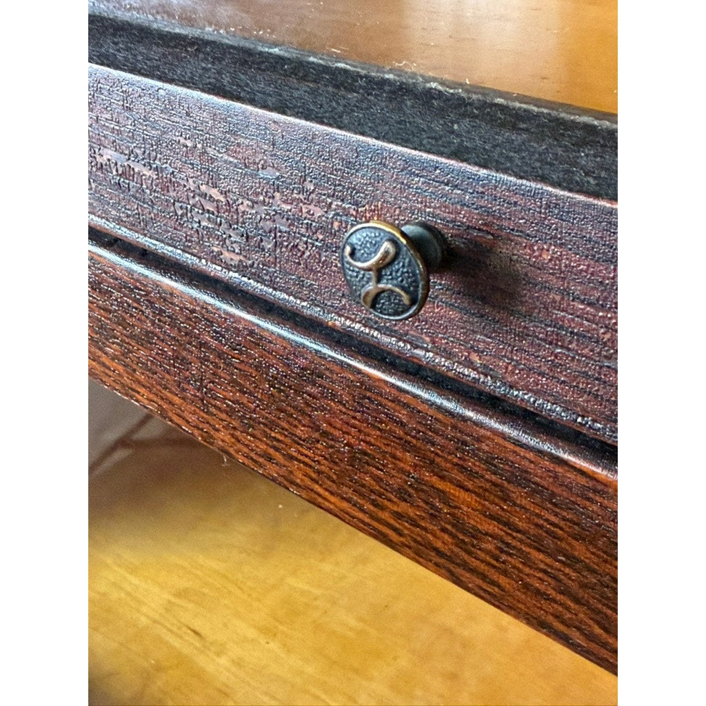Close-up of a dark wood drawer from the Camden Cabinet Company’s Antique Hale System Quarter-Sawn Oak Five-Stack Barrister Bookcase, c. 1910, featuring a round antique-style metal knob with a decorative pattern. The rich quarter-sawn oak grain and distinctive texture characteristic of the Arts and Crafts era are clearly visible in the light.