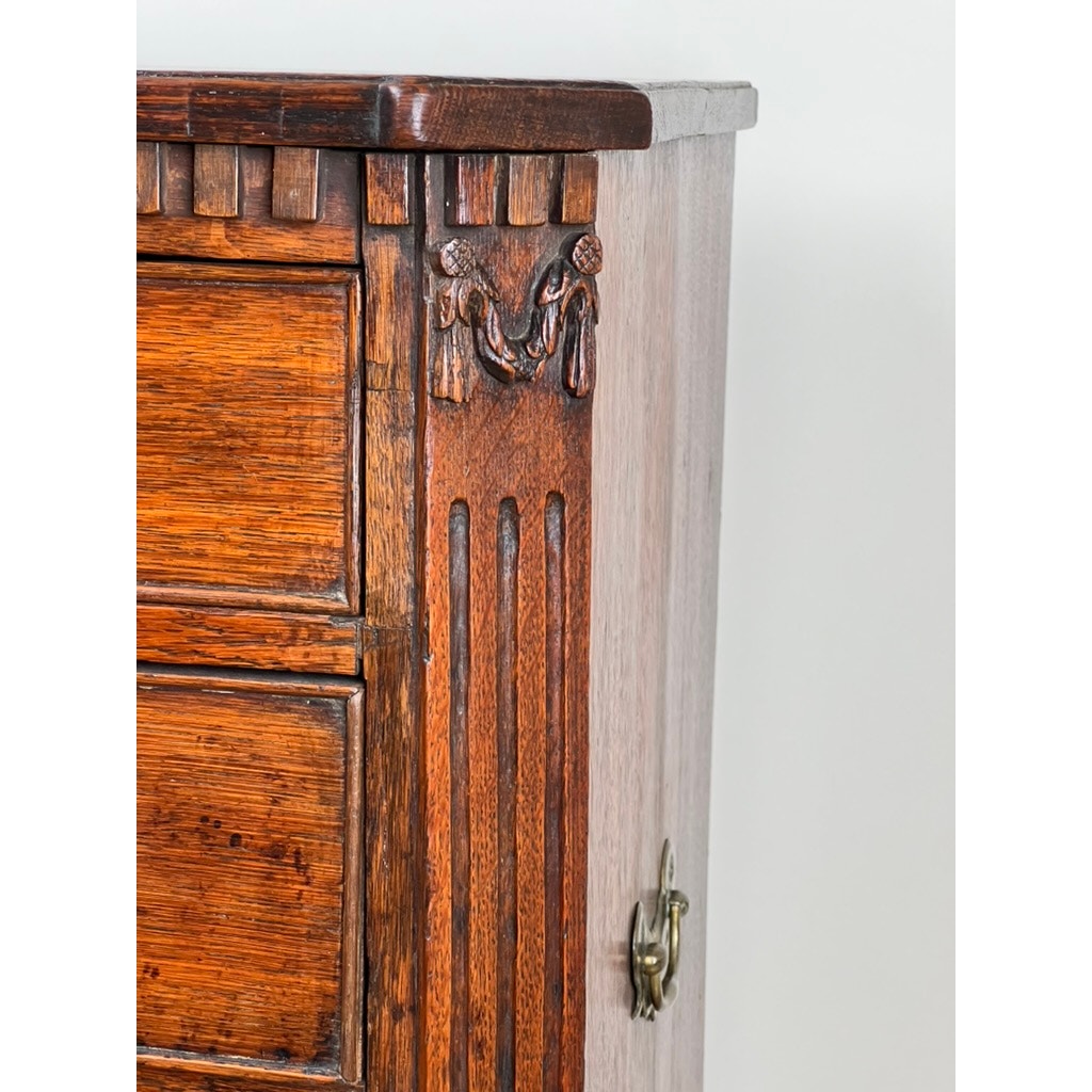 Detail of oak drawers with Louis XVI styling on late 18th century bachelors chest