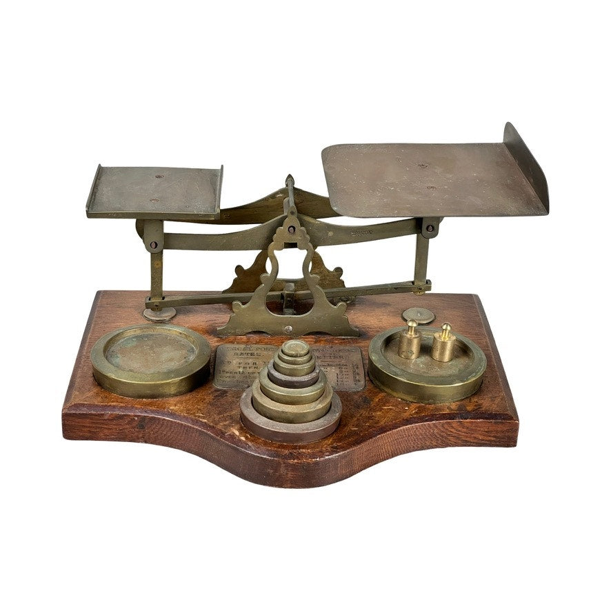 Antique 19th Century English Postal Scale—19th century English brass scale with dual pans on a wooden base, includes brass calibration weights; brand unknown.