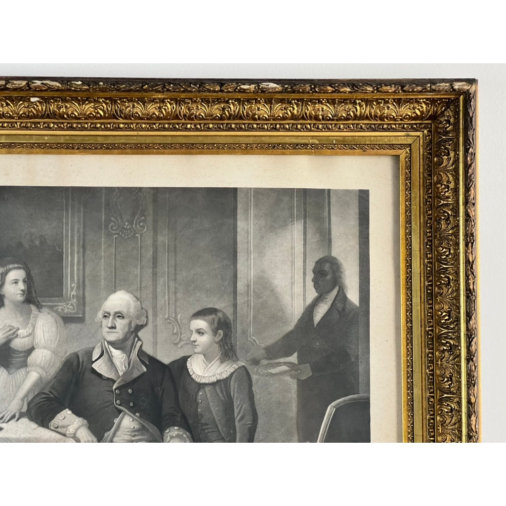 A close-up of an antique “Washington and His Family” engraving, published by Bradley & Co. in Philadelphia in 1858, displayed in a period gilt frame. The framed black-and-white historical print depicts George Washington seated with two others—one woman and one youth—while a standing figure in the background holds papers, reminiscent of the composition found in William Sartain engravings.