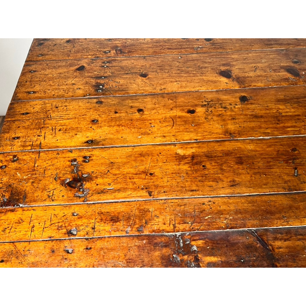 Close-up view of the Antique Country Pine Hutch Table with Six Plank Top, c. 18th Century, featuring visible grain, knots, scratches, and nail marks in warm brown tones for a worn and weathered farmhouse look. Brand: Unknown.