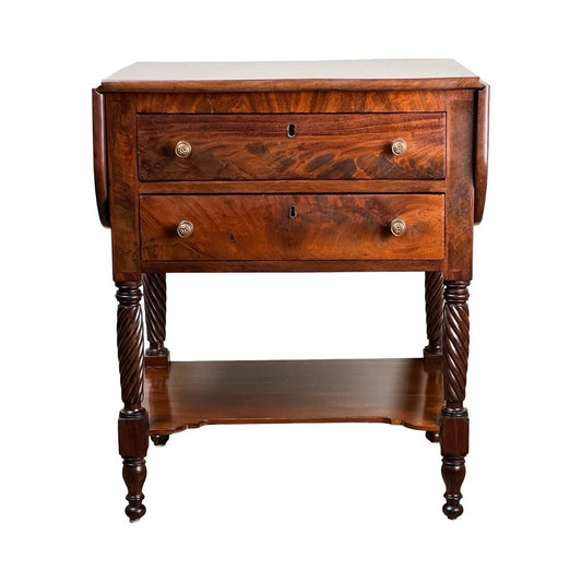 The Antique Federal Mahogany Two Drawer Work Stand c.1820 features lion’s head pulls, spiral-carved legs, a lower shelf, and fold-out side extensions. This vintage piece echoes early 19th-century American design in rich mahogany. Brand: Unknown.