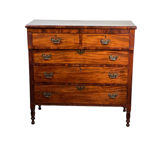 An Antique George III Sheraton Flame Mahogany Chest of Drawers from the early 19th century, featuring four drawers with ornate metal handles and turned legs, presented without brand on a white background.