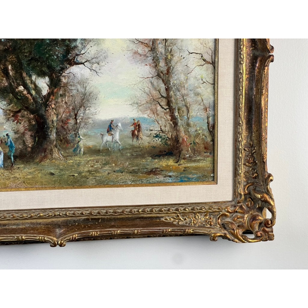 A close-up of the Vintage Guy Cambier Belgian Romantic Landscape Oil Painting (c. 1960–1980) shows horsemen riding through wooded scenery beneath a cloudy sky, with part of its ornate gold-toned frame in view. Brand unknown.