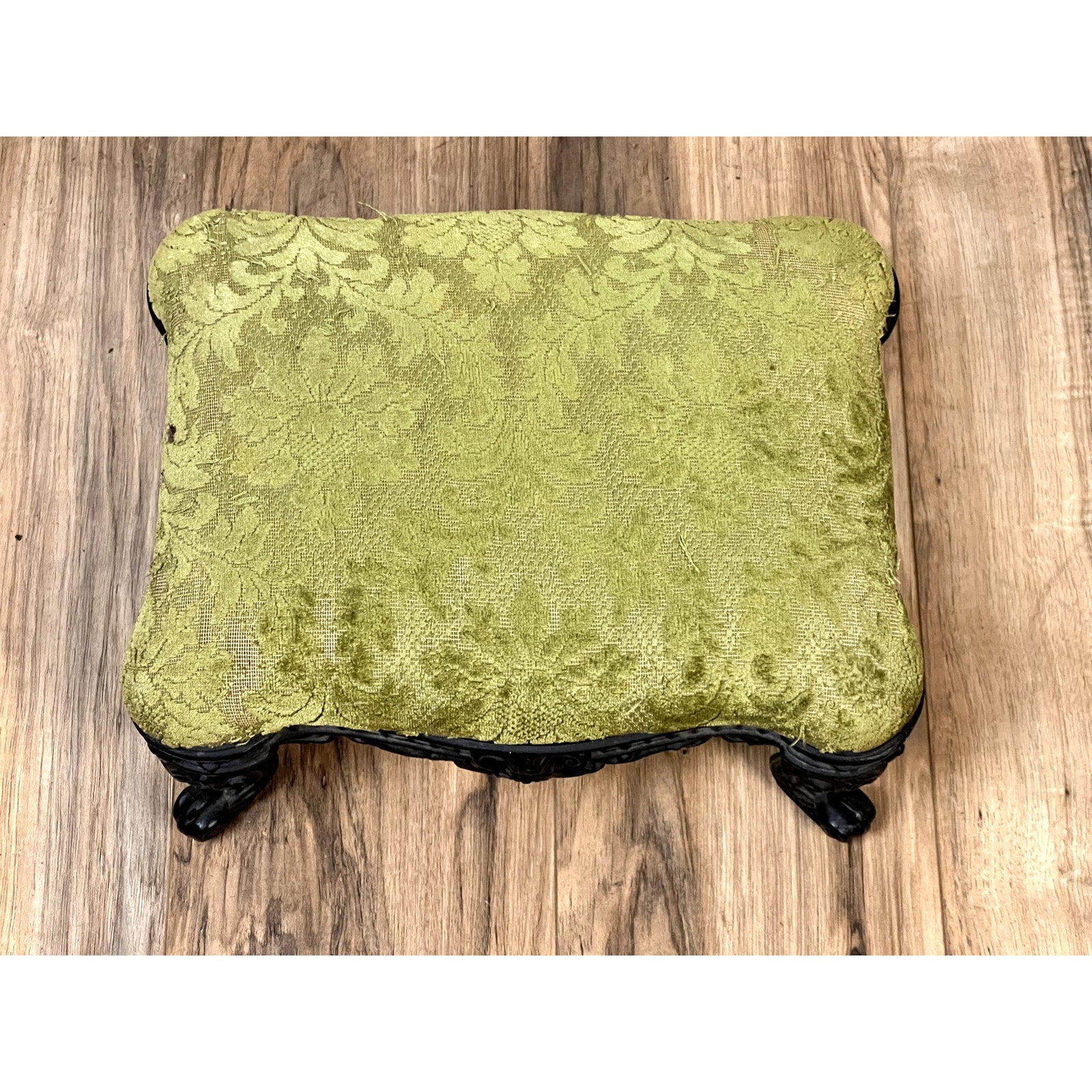 Antique Victorian Cast Iron Foot Stool c. 1900 with vintage green upholstery, subtle floral pattern, and ornate black legs—an ideal decorative accent for any space. Brand: None/Unknown.