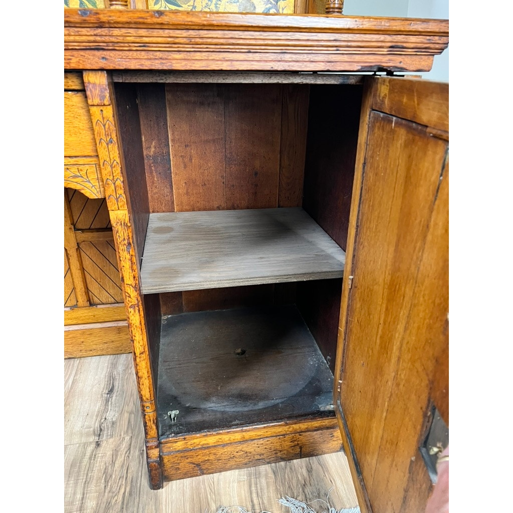 An Antique Victorian Aesthetic Movement Oak Desk in original finish (late 19th century) stands on a wooden floor, with a right-hinged door, single shelf inside, and visible wear including dust and circular marks. Brand: Unknown.