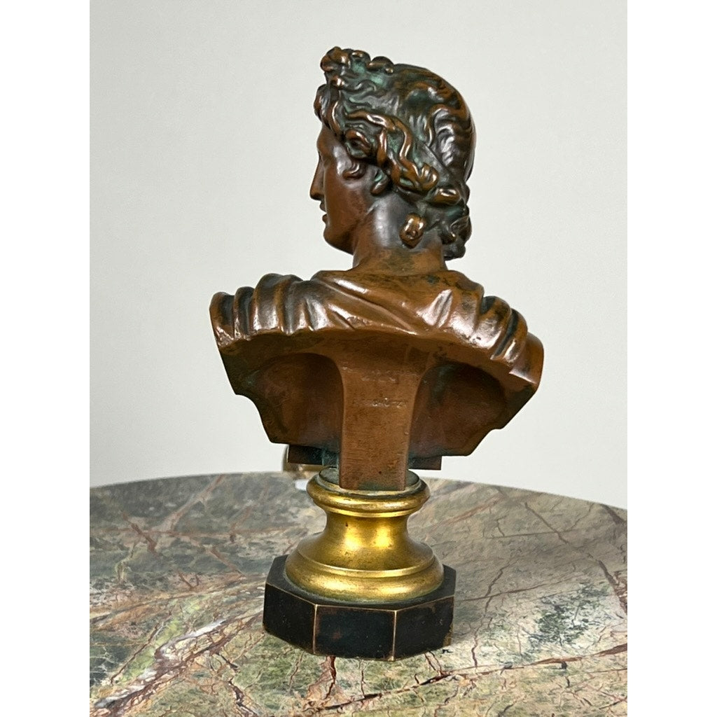 An antique small bronze of “the Apollo Belvedere,” marked by a Vienna foundry, features a gold and bronze neoclassical figure viewed from behind on a round marbled base, with detailed hair and drapery evoking classical elegance.