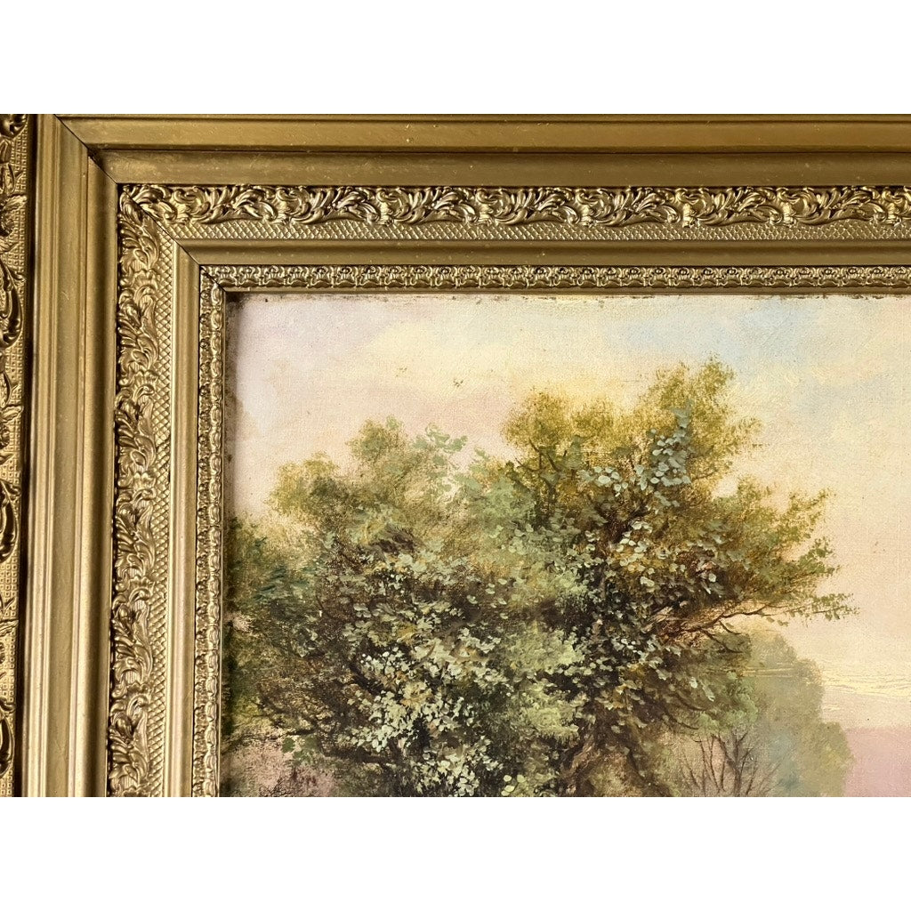 Close-up of the ornate gold frame around “Spectacle Bridge,” an antique early 20th century oil on canvas by Arthur Davis, showing textured green trees beneath a pastel sky; signature visible lower left. Brand unknown.
