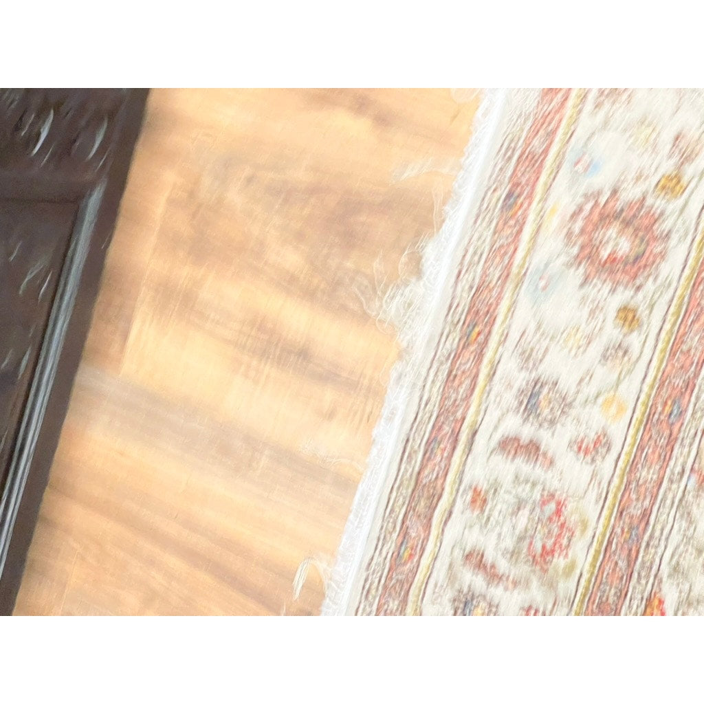A close-up of a patterned rug with fringed edges on a wooden floor; on the left is part of an Antique 18th Century Charles II Style Mule Chest, maybe Irish or Scottish, brand unknown.