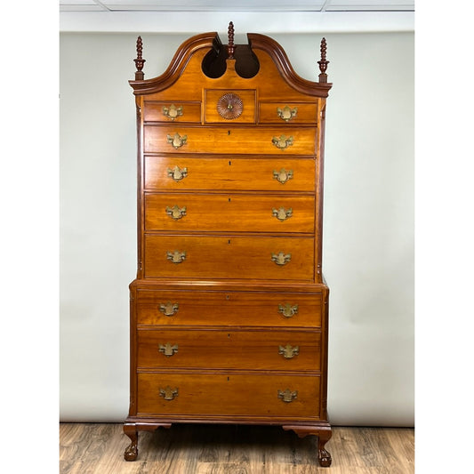 Rare Antique Chippendale Cherry Chest on Chest Attr. Nathan Booth, Woodbury CT c. 1760 by Pearl City Antiques: This tall wooden chest of drawers features ornate details, brass handles, a decorative carved sunburst, and turned finials on top. It stands elegantly on claw feet against a plain background, exemplifying the exquisite craftsmanship attributed to Nathan Booth of 18th-century Woodbury, Connecticut.