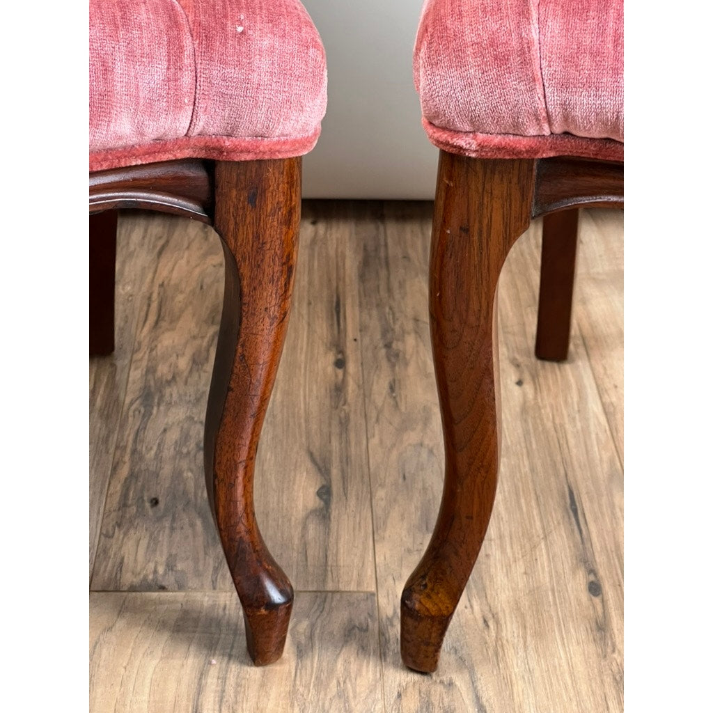 The legs of two Antique Victorian Walnut Balloon Back Tufted Side Chairs (late 19th c.) rest on a light wood floor, with their pink upholstered seats just visible at the top of the image.