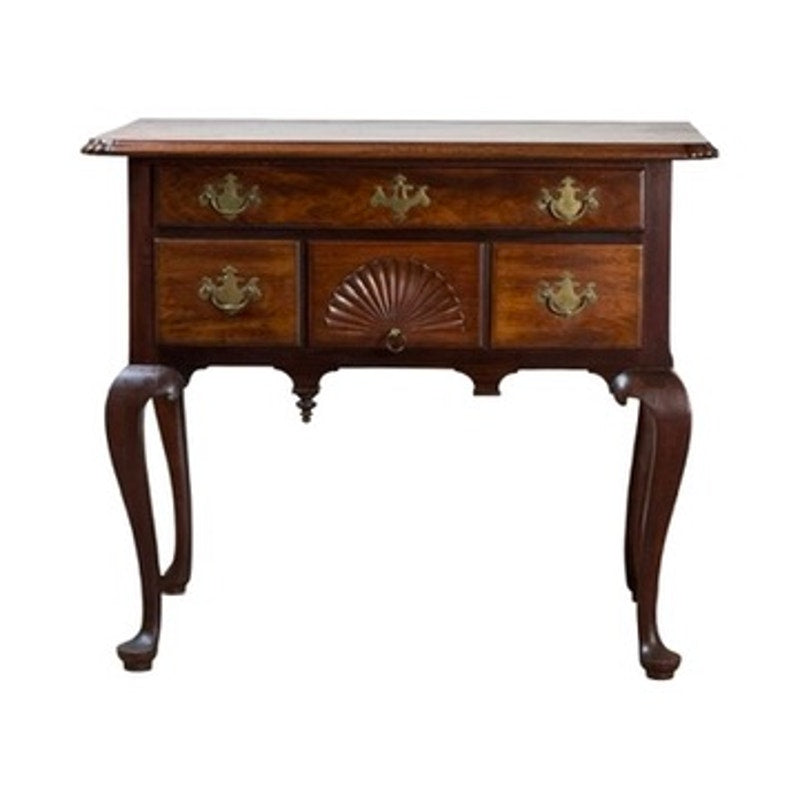 An 18th Century American Queen Anne walnut shell-carved lowboy, dating from circa 1740–1770, featuring three drawers with ornate brass handles and carved details including a fan (shell) motif, standing on four curved legs.