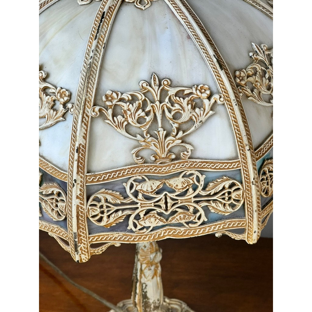 Close-up of a Vintage Art Nouveau Slag Glass Two-Light Table Lamp (c. 1935–1955), showing intricate gold filigree and floral patterns on cream slag glass; the ornate base is partially visible. Brand: None/Unknown.