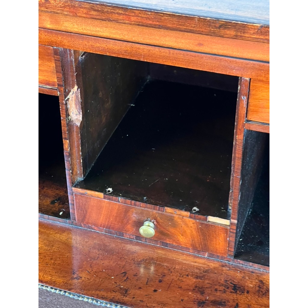 A close-up of an empty wooden cabinet from an Antique George IV Butlers Secretary (early 19th century); a round brass knob and chipped wood evoke Regency style, while the worn interior suggests years of use. Brand: unknown.