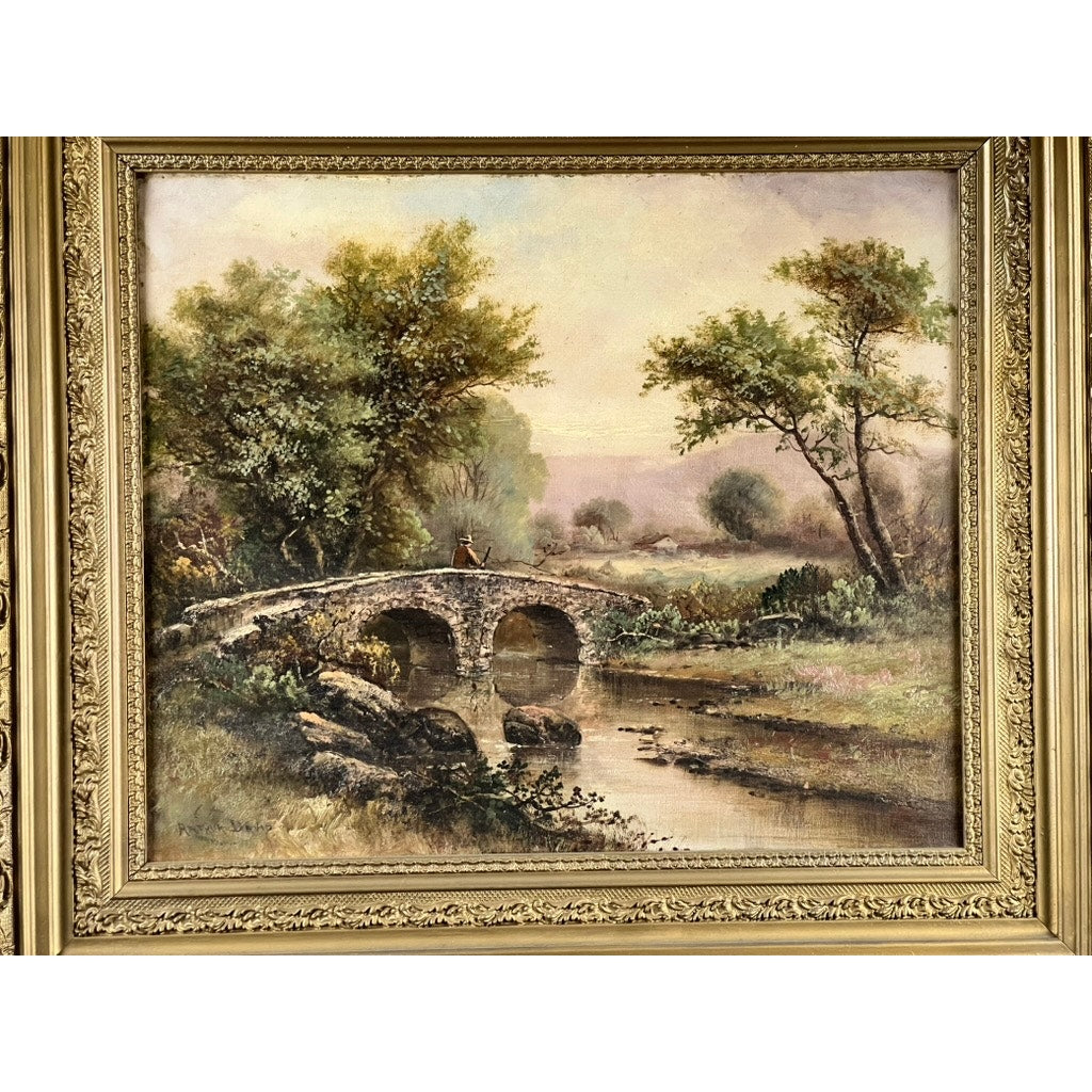 An Antique Early 20th Century oil on canvas painting titled “Spectacle Bridge,” signed Arthur Davis lower left, shows a stone bridge over a calm river with lush greenery, a figure on the bridge, and a hazy sky in the background.