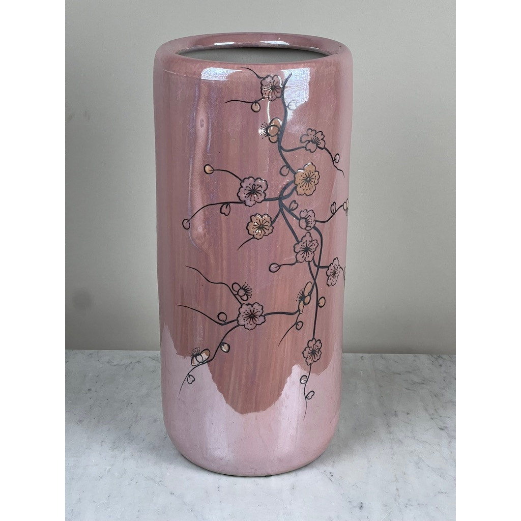 The Vintage Sakura Style Cherry Blossom Tall Vase features a glossy pink finish with a black and yellow floral branch design. This modern ceramic decor piece is shown on a light marble surface against a neutral background.