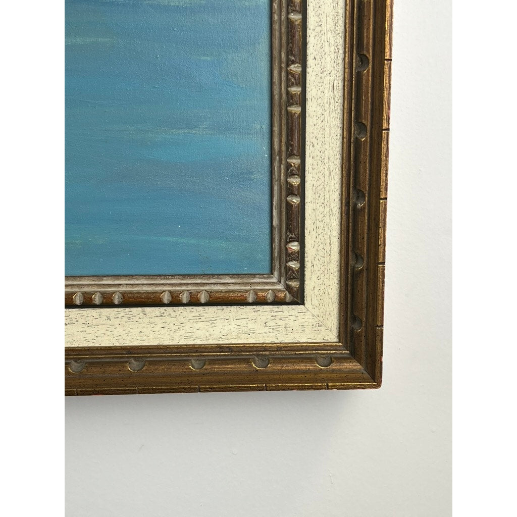 Close-up of the bottom right corner of the “Naples Harbor” oil painting (28 x 52, signed lower left C. Ciappa), showing its ornate frame and blue-toned coastal scene on canvas against a white wall. Brand: Unknown.