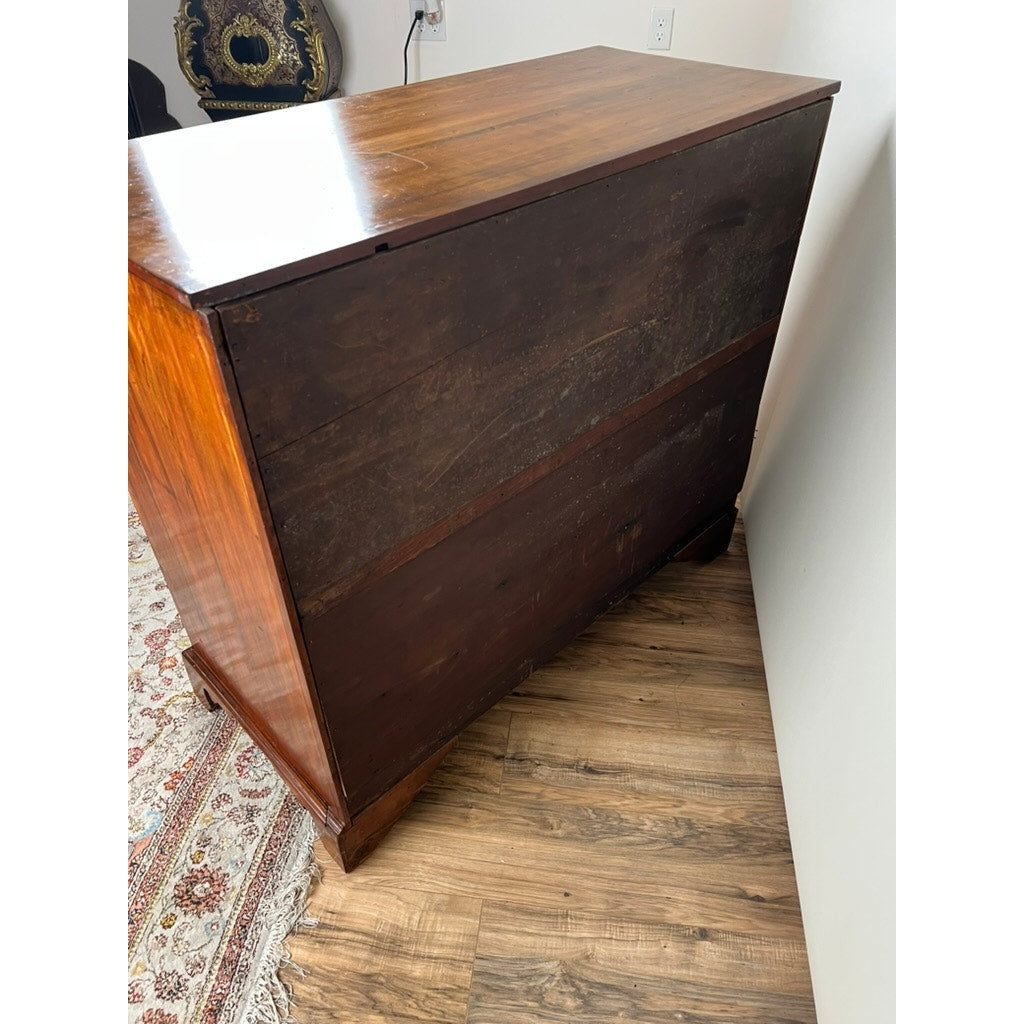 A wooden dresser stands on a wood floor by a white wall and patterned rug, its back worn and dark. In the background, an Antique George IV Butlers Secretary c. Early 19th Century is partially visible. Brand: Unknown.