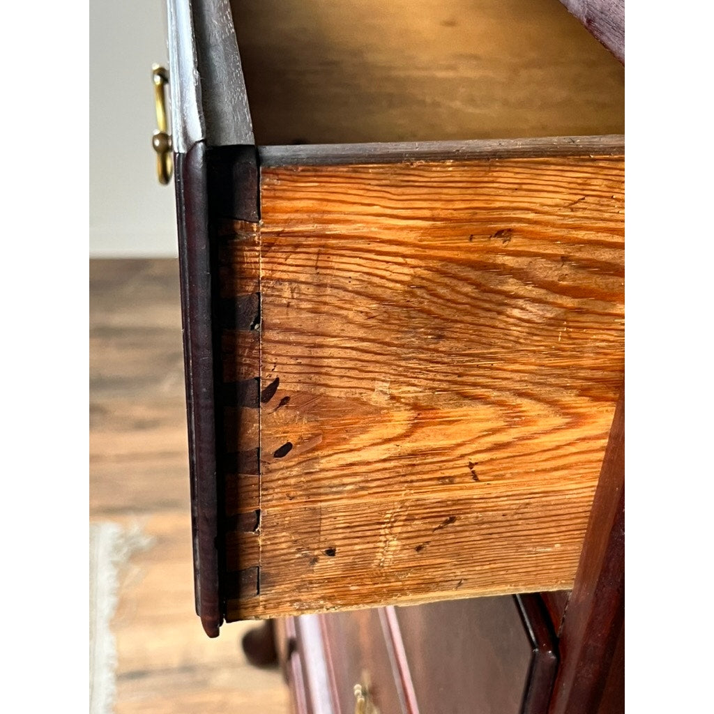 A close-up shows dovetail joints and wood grain on a marked drawer from an Antique Queen Anne Walnut Chest on Frame with Drake Feet, probably Irish, late 18th century—a dark-stained piece with a brass handle.