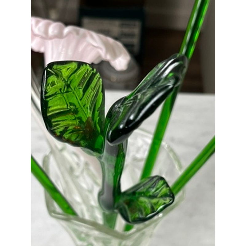 Close-up of vintage Murano art glass bouquet, featuring hand-blown green leaves, stems, pink flower, and butterflies from the "Vintage Bouquet Murano Art Glass Long Stem Flowers and Butterflies" collection in a clear vase.