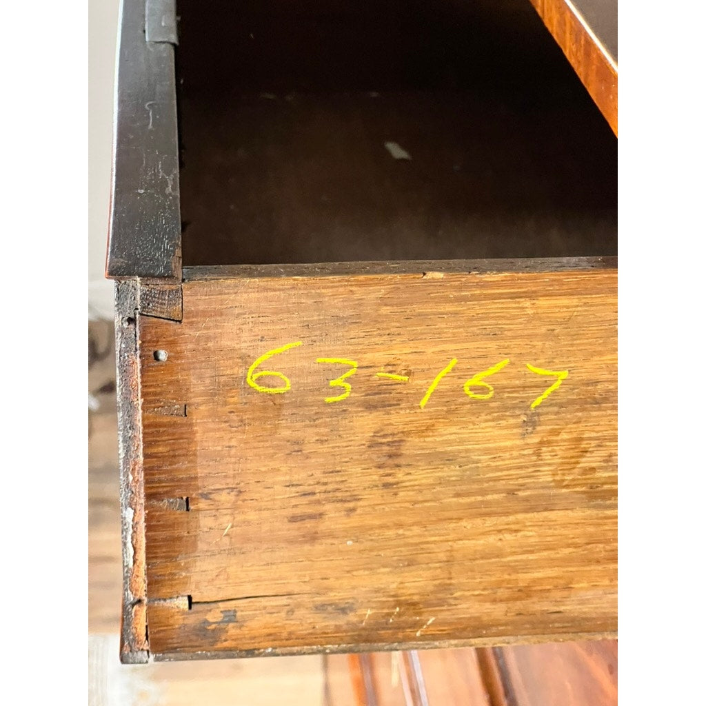 A close-up of an open drawer from an Antique George III Two Over Four Chest with French Feet (early 19th c.), showing handwritten yellow numbers 63-167 near the dovetail joints; the interior is empty.
