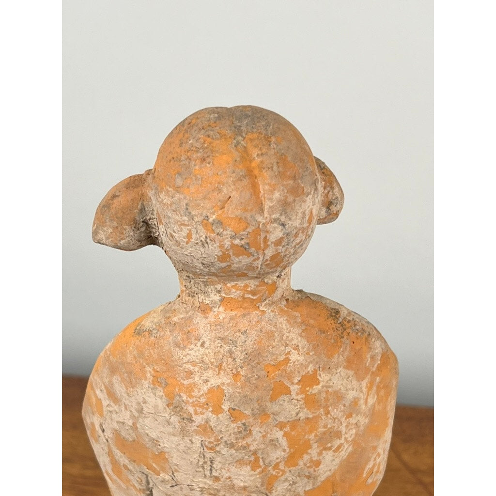 Viewed from behind, this Antique Chinese Tang Dynasty (618-907 AD) terracotta figure of a standing court lady displays a weathered, orange-brown finish, rounded head with ear-like shapes, and a textured surface. Includes COA. Brand: None/Unknown.