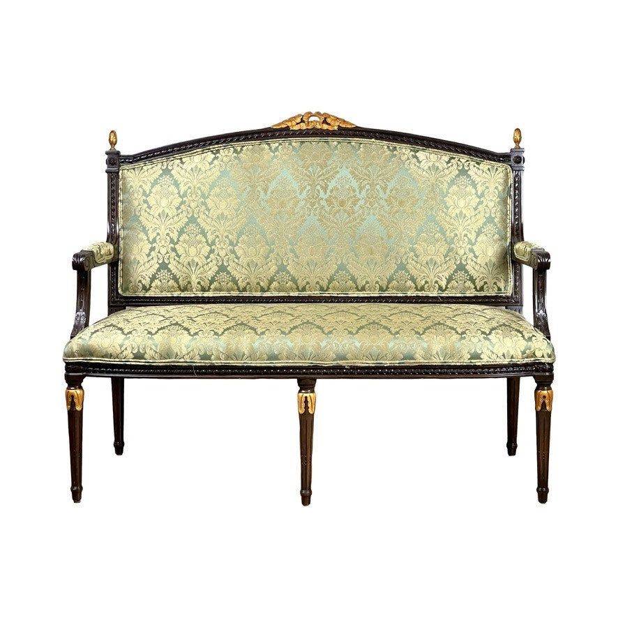 A Vintage Louis XVI Style Settee in green damask upholstery features ornate carvings, gold accents, a high back, and armrests, shown against a white background. Brand: None or unknown.
