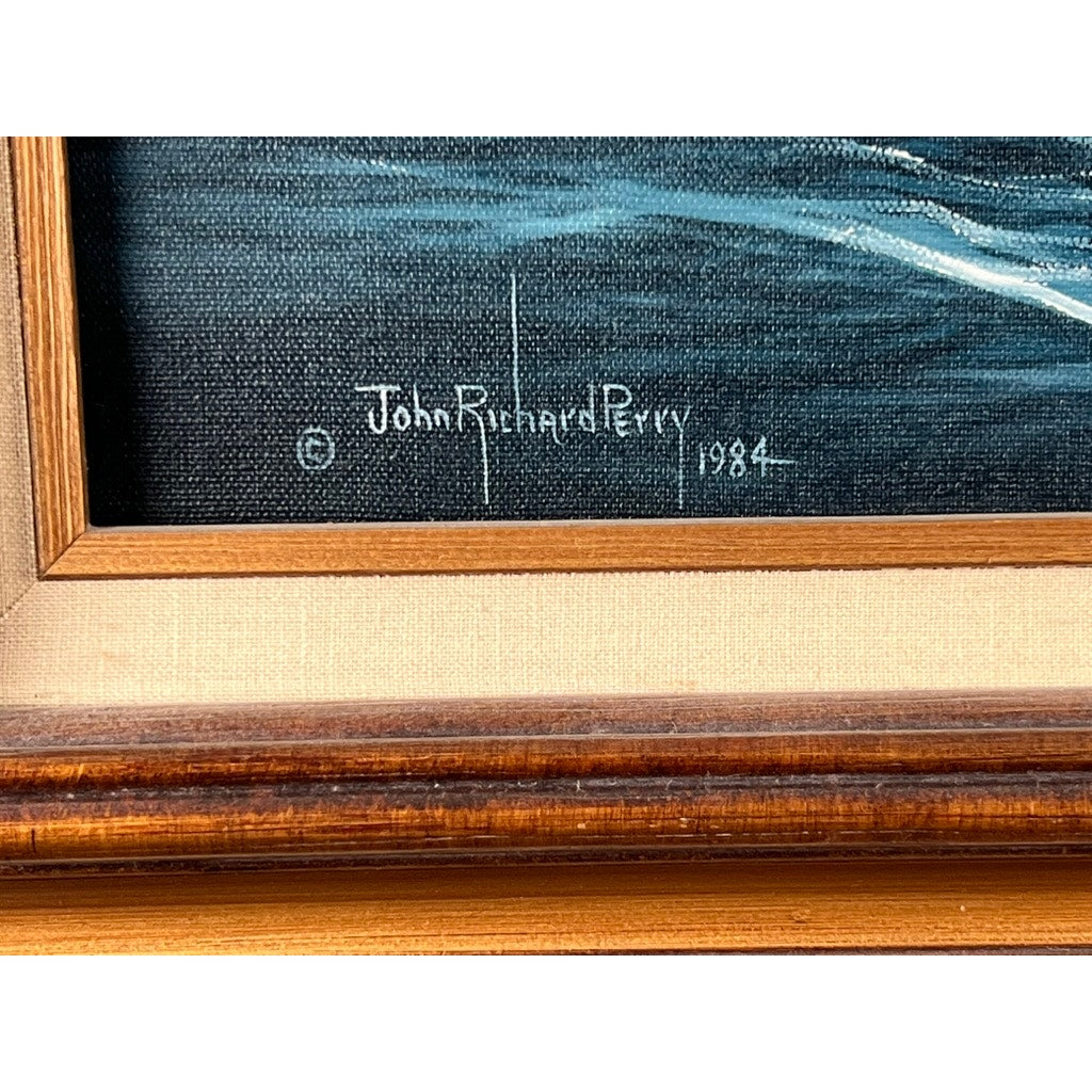Close-up of John Richard Perry’s 1984 signature in white on a dark background, with wooden frame and light canvas—details from his “Tall Ship Under Sail” oil on canvas.