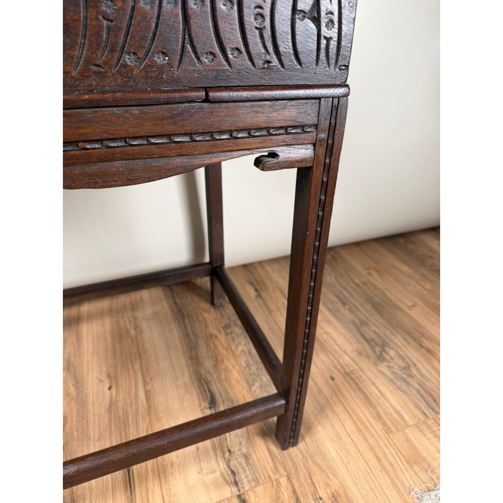 English Jacobean Carved Oak Bible Box on Later Stand, c. Late 17th Century, sitting on a four-legged table stand.