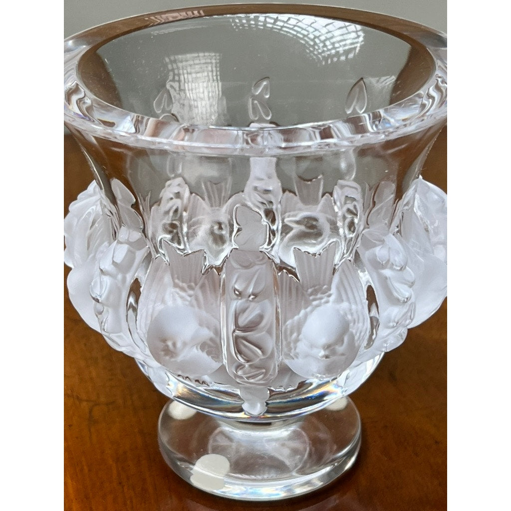 The Vintage Lalique Dampierre Sparrow Footed Vase by Lalique is a clear French crystal piece with frosted sparrow accents and raised patterns, featuring intricate details and a flared rim—an elegant collectible displayed on wood.