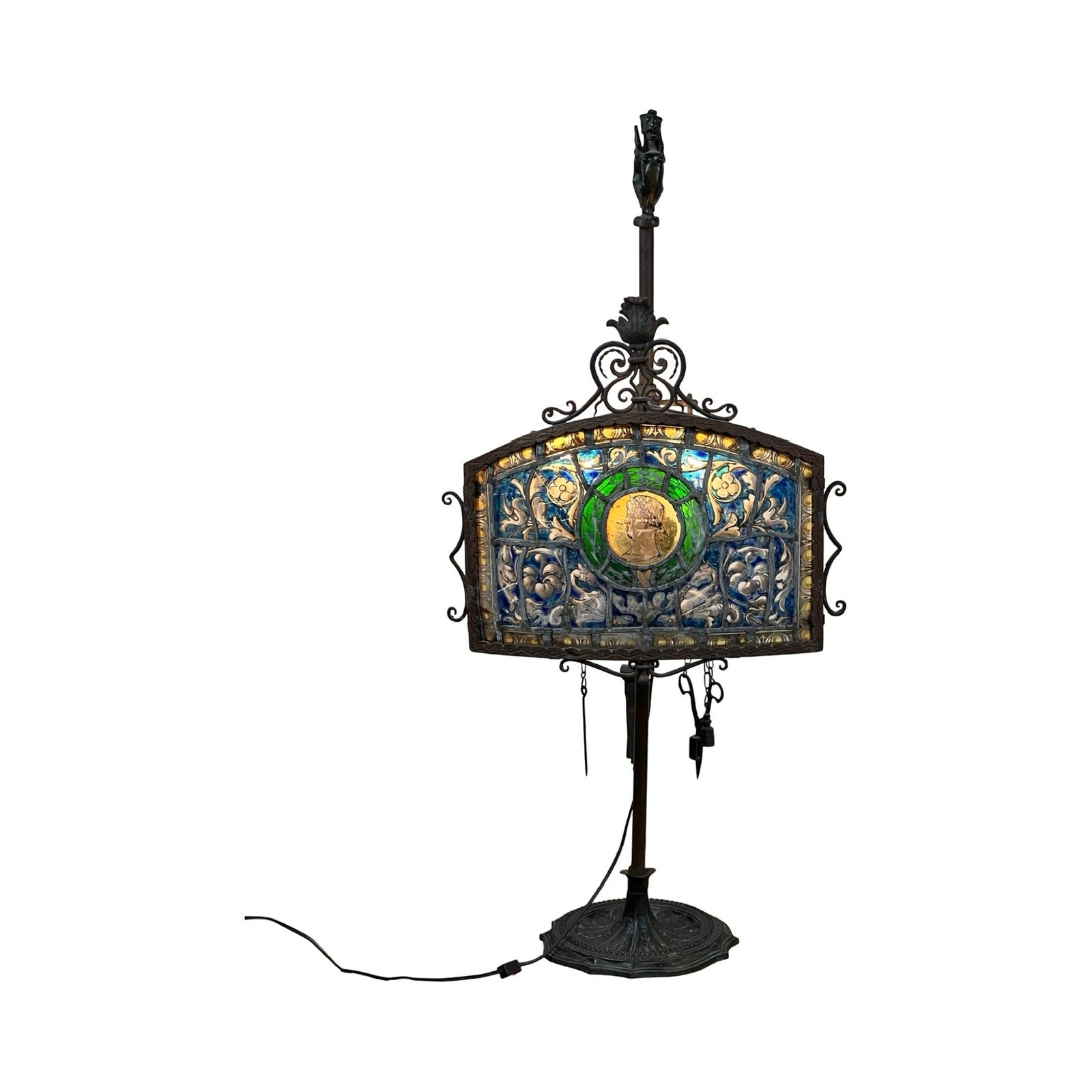 Antique Five Burner Lucerne Whale Oil Lamp with Napoleon I Fireplace Screen Shade features colorful blue, green, and gold patterns on a rectangular shade atop a dark metal stand with round base and visible power cord. Brand unknown.