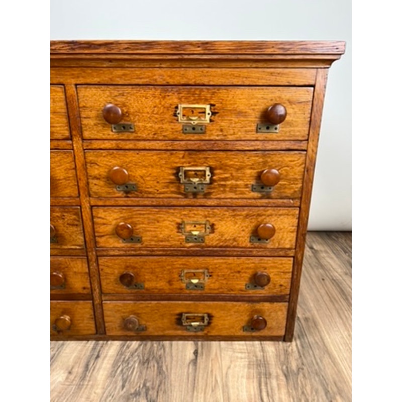 Early 20th century oak file cabinet with multiple drawers, antique office furniture.