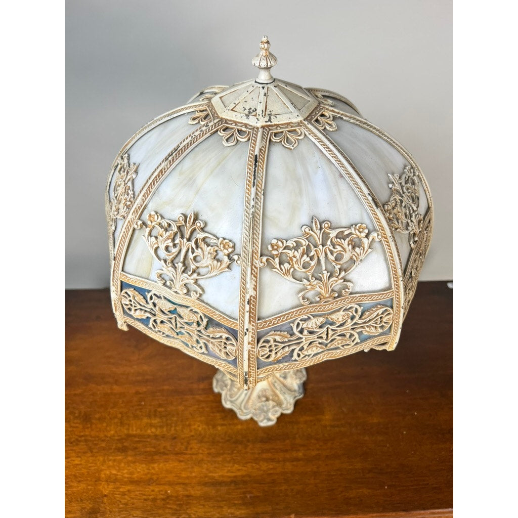 The Vintage Art Nouveau Slag Glass Two-Light Table Lamp (c. 1935–1955) features an ornate dome-shaped stained glass shade and carved base, adding decorative lighting to any wooden surface. Brand: Unknown.