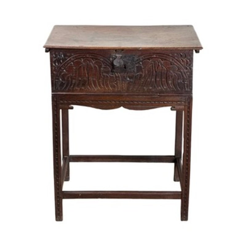 An English Jacobean Carved Oak Bible Box on Later Stand by Pearl City Antiques, featuring intricate floral carvings on an oak box mounted to a four-legged table stand.