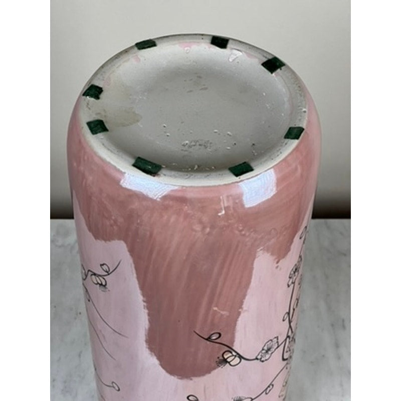 A close-up of the unglazed base of the Vintage Sakura Style Cherry Blossom Tall Vase. Black floral designs decorate the pink ceramic, and green felt pads are spaced around the edge for protection and style. Brand: Unknown.