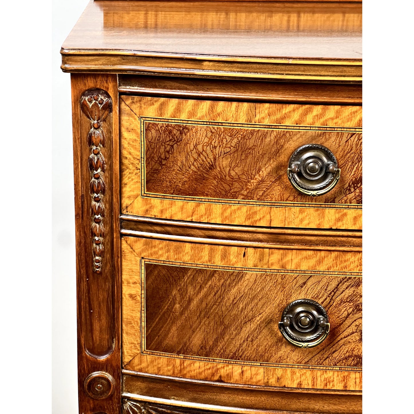 Close-up of the Vintage Federal Style Bow Front Mahogany Sideboard by Paine Furniture Boston, featuring two drawers with ornate metal handles, carved wood details along the frame, and rich mahogany grain.