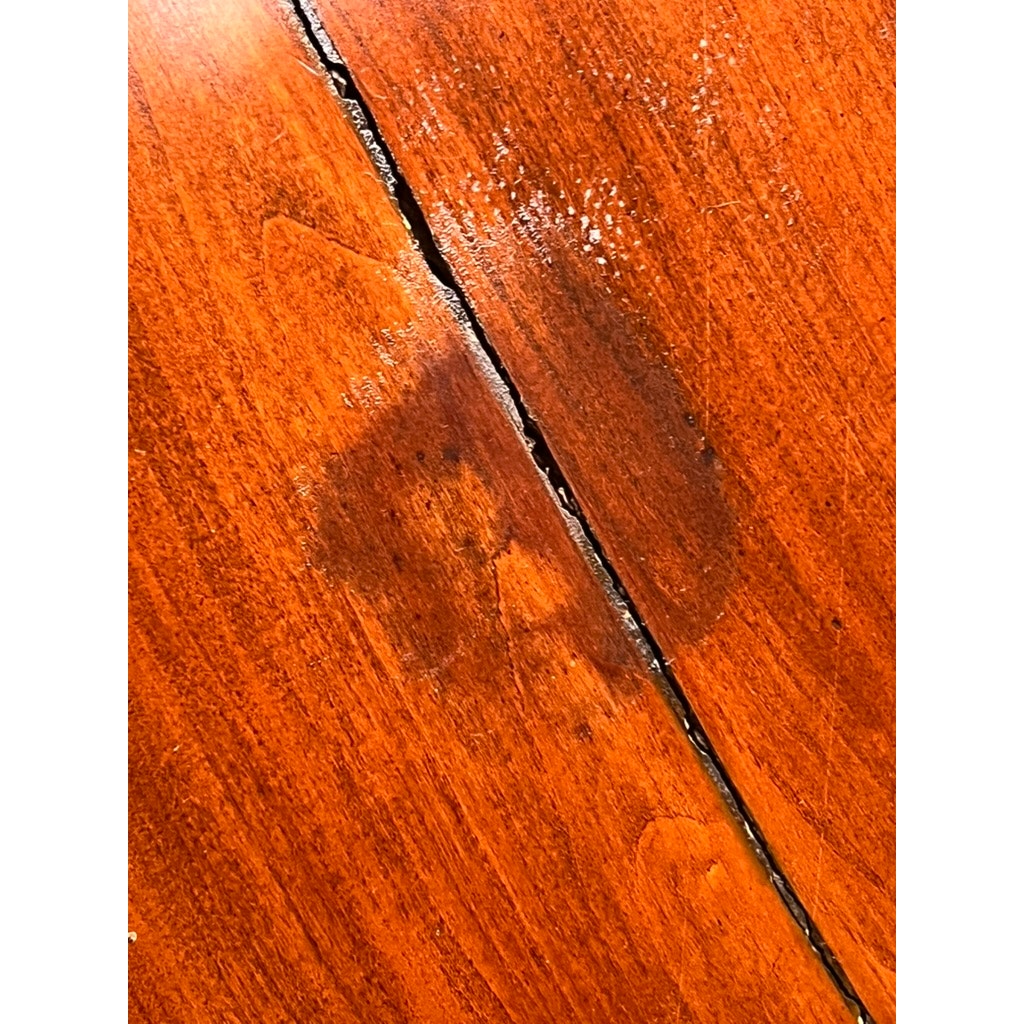 A dark, heart-shaped water stain and a prominent vertical crack are visible on the polished surface of this early 19th-century Antique Sheraton Mahogany Bowfront Chest. Brand: None/Unknown.