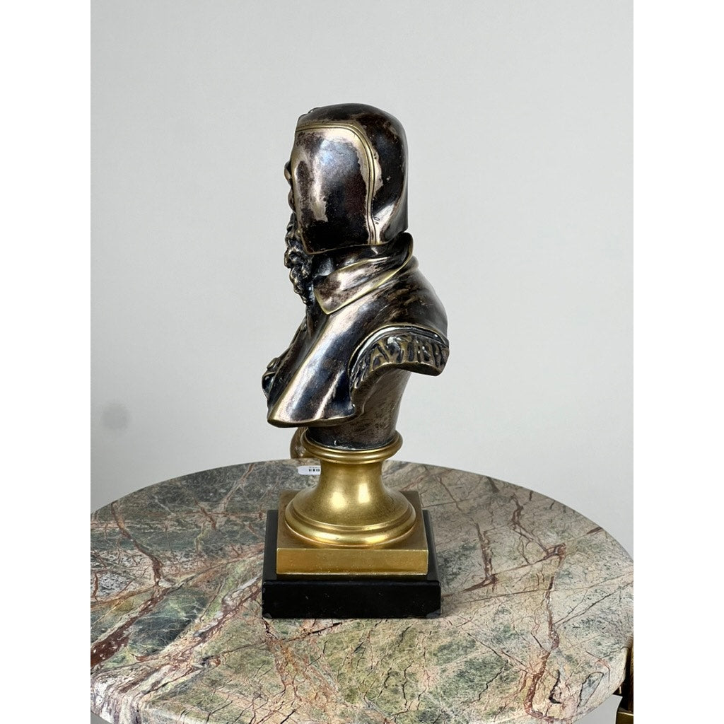 A patinated bronze sculpture of Michelangelo by Albert-Ernest Carrier-Belleuse, modeled before 1883 in Paris, is shown on a gold and marble pedestal atop a multicolored marble table against a plain background.